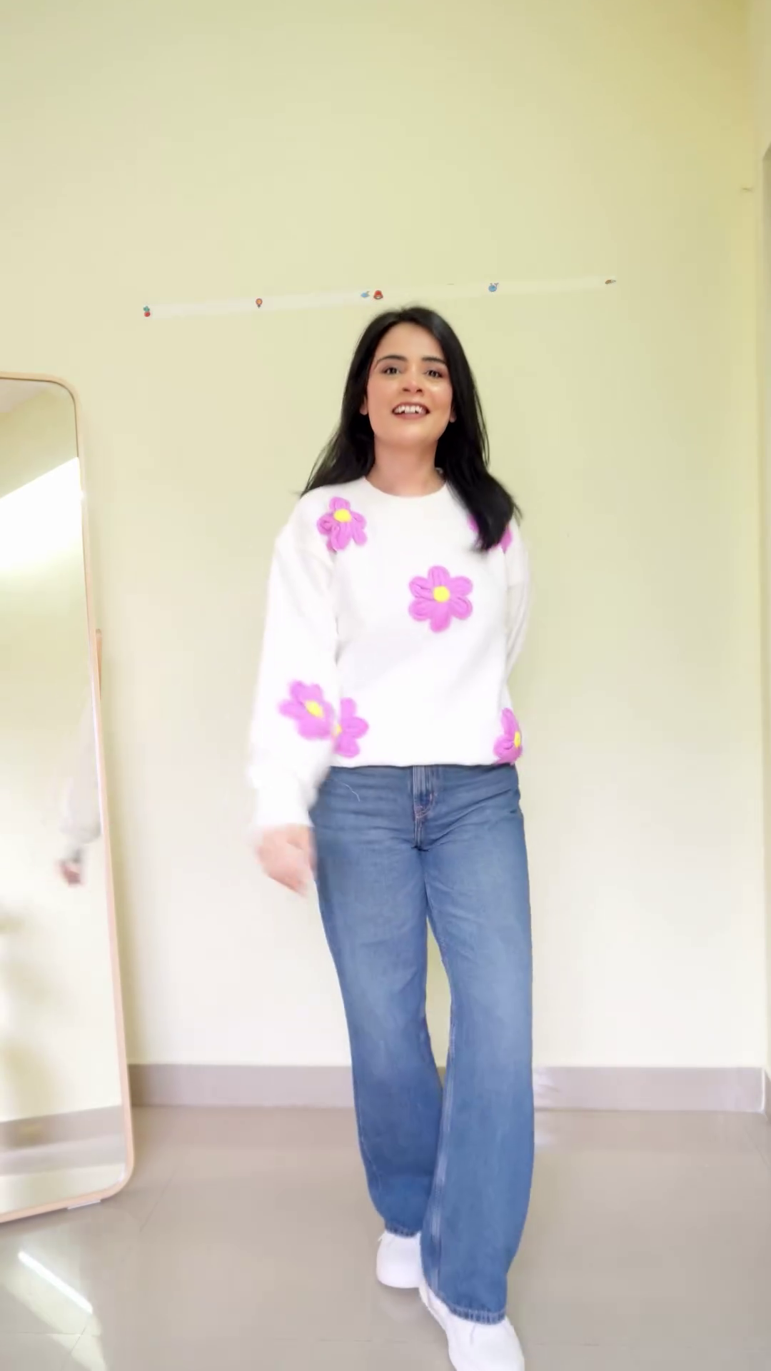 Soft White Fleece Pullover Sweatshirt with Multicolor 3D Bow Appliqué Embellishments and Relaxed Balloon Sleeves Paired with Classic Blue Wide-Leg Denim Jeans - Image 3